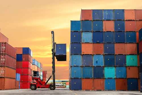 Forklift carrying a shipping container